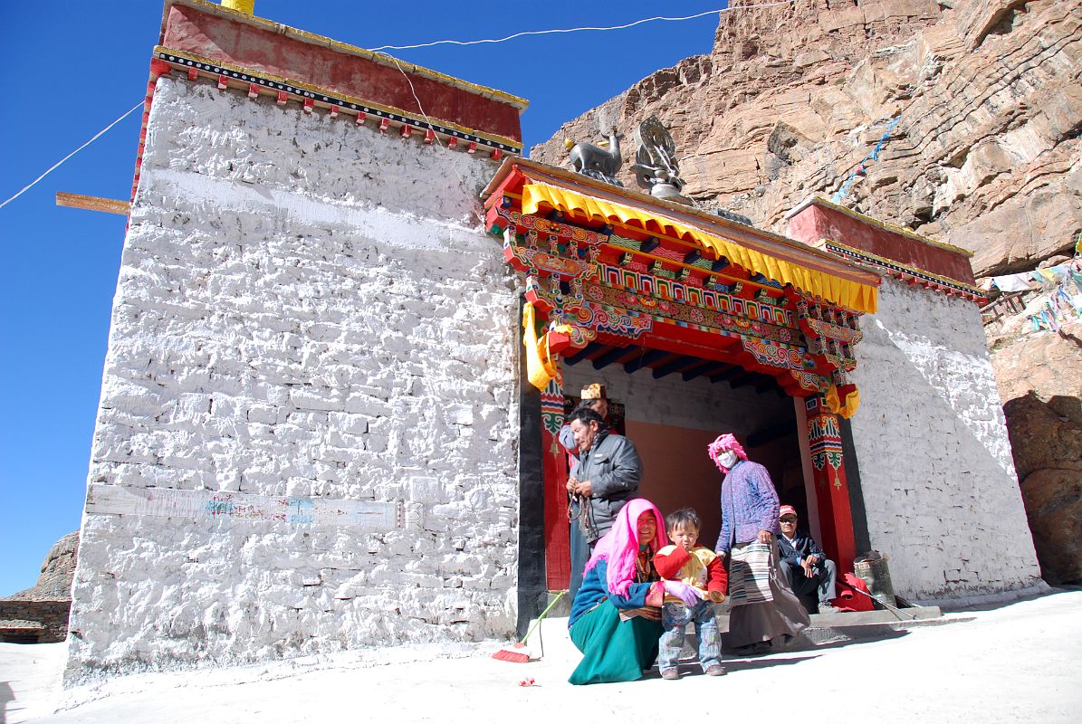 11 Chuku Nyenri Gompa Entrance With Tibetan Pilgrims On Mount Kailash Outer Kora Tibetan pilgrims circumambulate the Chuku (Nyenri) Gompa. Chuku Gompa was founded by Gotsangpa (1189-1258), a Kagyu disciple, and was the first Kailash Gompa to be rebuilt after the destruction of Cultural Revolution.